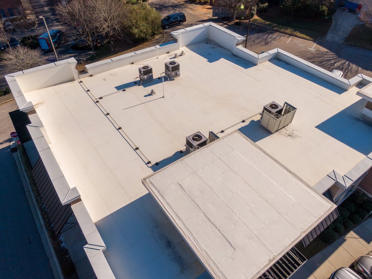 Commercial and industrial buildings with TPO flat roofing systems showcasing modern energy-efficient roofing